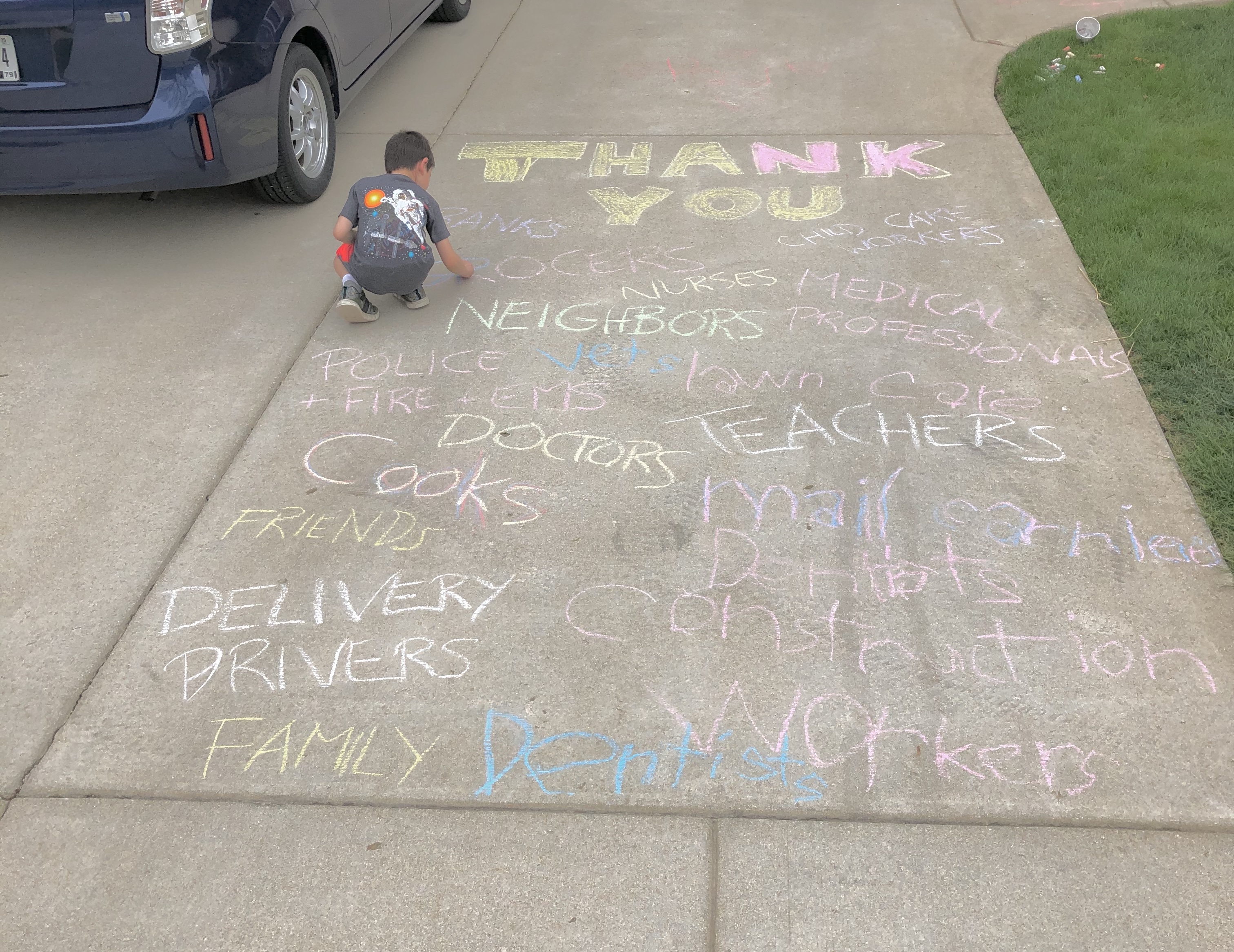 Child writing with sidewalk chalk